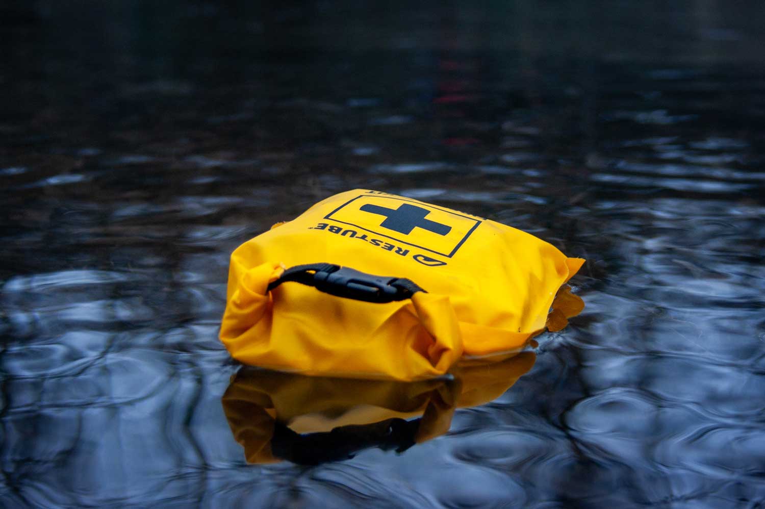 First Aid kit swimming in the water of a river
